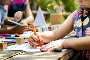 young child colouring in outside